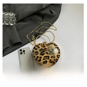 Detailed top view of leopard print heart-shaped bag with gold chain and metal handle