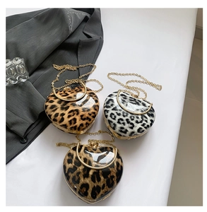 Detailed view of heart-shaped leopard print handbags in three stylish patterns and gold handles