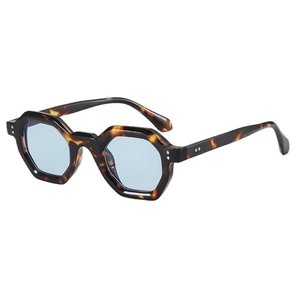 Trendy hexagonal tortoiseshell sunglasses with light blue lenses and rivet details