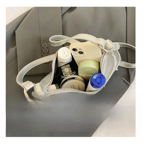 Interior view of silver metallic shoulder bag showing large storage capacity for cosmetics