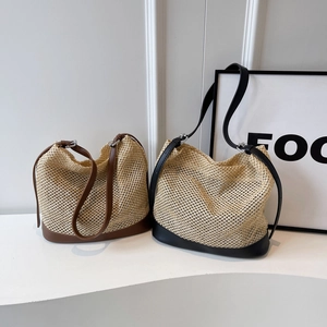 Minimalist woven straw shoulder bags in black and brown with adjustable leather straps