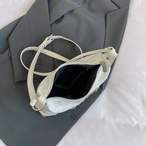 Minimalist white half-moon hobo bag with silver chain strap and top zipper closure