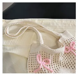 Close-up of comfortable wide knit strap and delicate woven texture with pink bow