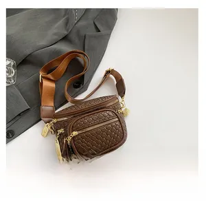 Close-up of brown woven leather bag featuring gold zippers and adjustable strap