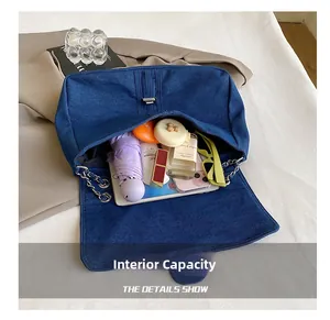 Detailed top view of large capacity denim shoulder bag interior with daily essentials