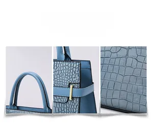 Detailed view of light blue crocodile embossed handbag showing quality stitching and hardware