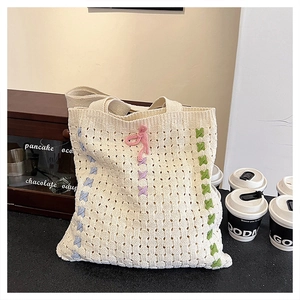 Chic woven knit tote bag in cream white with colorful floral accents for women