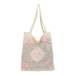 Handmade cream woven tote bag with pink knitted bow details and mesh crochet texture
