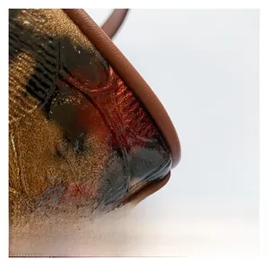 Macro shot of brown faux crocodile leather texture with glossy finish and durable stitching