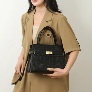 Classic black crocodile texture handbag with gold rotary buckle for a stylish business look