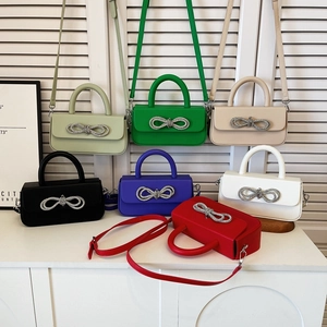 Chic box crossbody bags with rhinestone bow in seven vibrant colors on white background