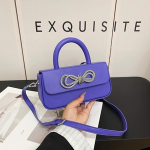 Elegant purple glossy leather handbag with sparkling silver rhinestone bow and top handle