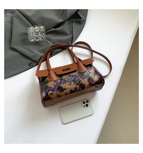 Detailed top view of retro crossbody bag with floral embossing and braided handle