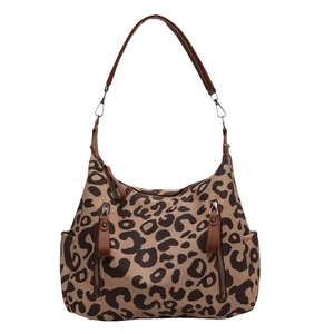 Leopard print canvas crossbody bag with brown leather straps and metal zippers