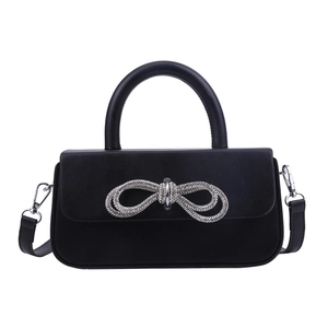 Elegant black leather handbag with a sparkling rhinestone bow and detachable strap