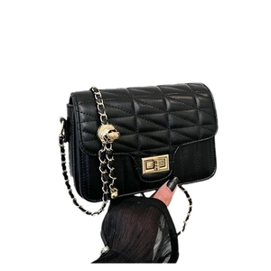 Classic black quilted square handbag with gold metal lock and chain strap on white background