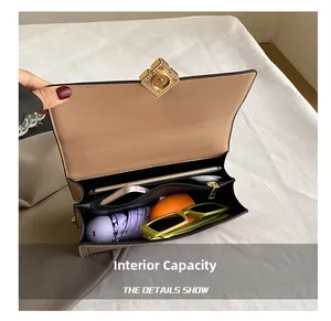 Detail showing the large capacity interior with multiple compartments of the crossbody bag