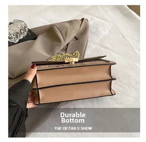 Detail of the wear-resistant bottom and double-layer structure on khaki snake-texture bag