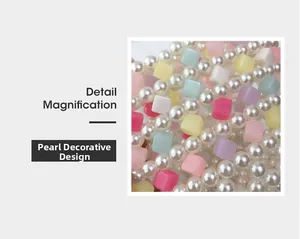 Detailed close-up of macaron colored cube beads and glossy white pearls on a handbag