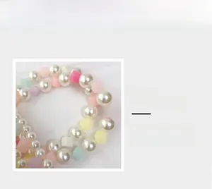 Detailed close-up of handmade beaded bag handle with colorful acrylic cubes and pearls