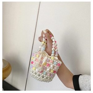 Detail of beaded mini handbag with pastel candy blocks and elegant silk ribbon bow