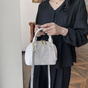 Chic white snake-textured shell bag with gold hardware and versatile crossbody strap