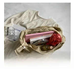 Interior view of large straw tote bag showing spacious capacity and zipper pocket
