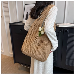 Close-up of woven straw handbag with hollow crochet detail and elegant French style texture