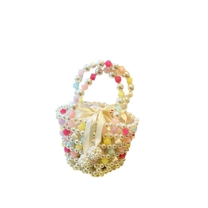 Handmade woven pearl mini handbag with colorful square beads and a white satin bow detail
