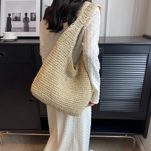 Minimalist beige woven tote bag with wide straps for summer vacation style