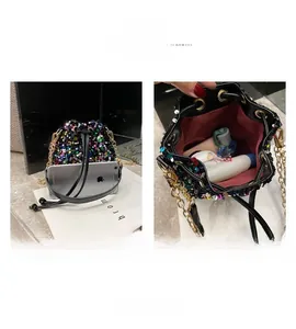 Close-up of holographic sequin bucket bag featuring drawstring closure and gold chain strap
