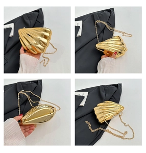 Detailed views of gold shell-shaped clutch bag with sleek metallic ribs and chain strap