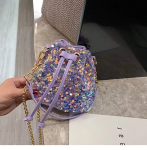 Detail of purple sequin bucket bag with iridescent glow and gold chain strap