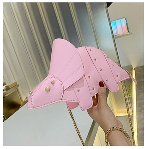 Detailed view of pink dinosaur shoulder bag with golden studs and metal chain strap