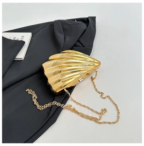 Elegant champagne gold shell-shaped evening clutch bag with quilted texture and chain
