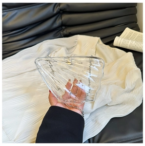 Transparent acrylic shell-shaped crossbody bag with silver chain and wavy texture