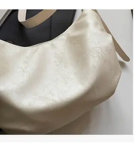 Macro detail of creamy white jacquard fabric with elegant bamboo leaf texture