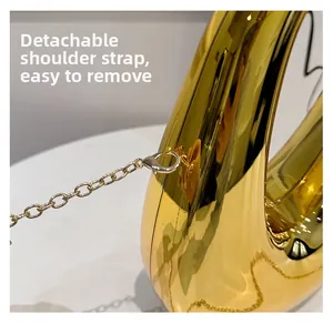 Macro detail of detachable gold metal chain strap with silver lobster clasp hardware