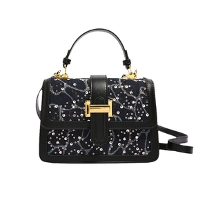 Blue denim crossbody bag with silver sequin floral embroidery and gold metal buckle