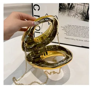 Detailed internal structure of a gold metallic spherical handbag with delicate chain