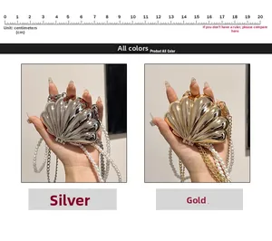 Close-up of mini shell-shaped metallic crossbody bag with pearl and metal chain straps