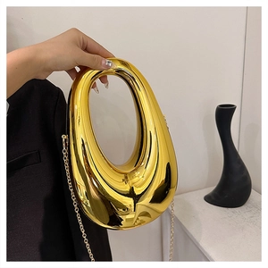 Close-up of golden mirror finish hollow drop-shaped handbag with fine chain link detail