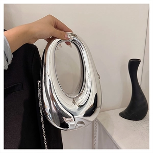 Detail of silver mirror drop bag showing the reflective finish and detachable chain