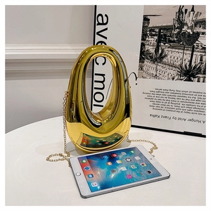 Detailed view of the gold mirror finish and curved silhouette of this luxury chain handbag