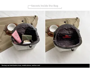 Detail view of the quilted shell bag interior showing a large main compartment and zipper pocket