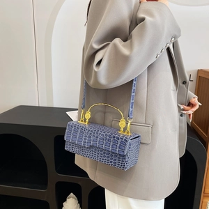 Navy blue crocodile pattern evening bag with golden handle and crossbody strap