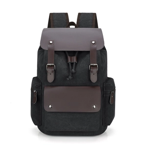 Retro black canvas backpack with brown leather flap and drawstring closure for daily use