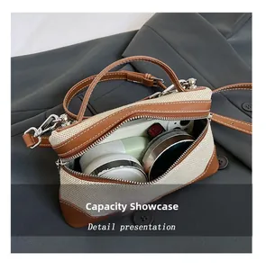 Detail view of the spacious inner storage of this canvas and brown leather crossbody bag