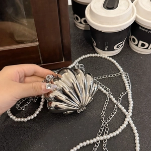 Elegant silver shell-shaped evening bag with pearl chain and metal strap