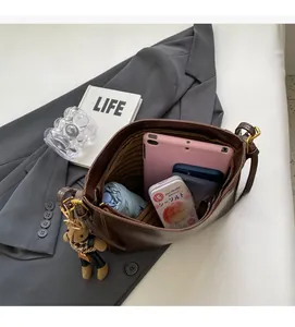 Interior view of brown leather bucket bag showing capacity for tablets and daily items